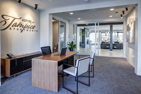 A modern office space with a wooden desk and chairs.