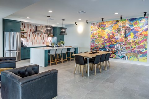 A modern kitchen with a dining table and chairs.