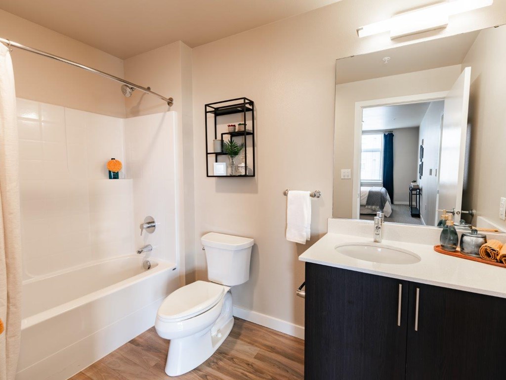 A white toilet sits next to a white sink in a bathroom.