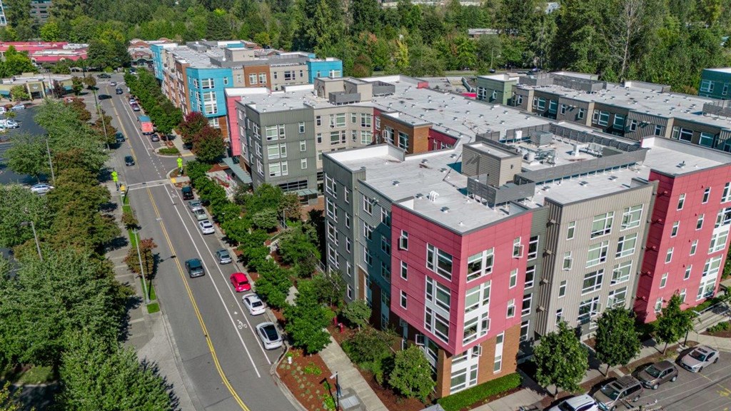 A street view of a residential area with multi-story buildings.