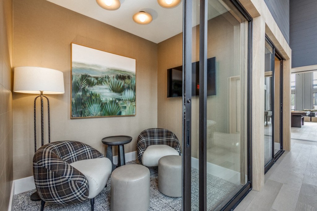 a living room with a couch and chairs and a tv