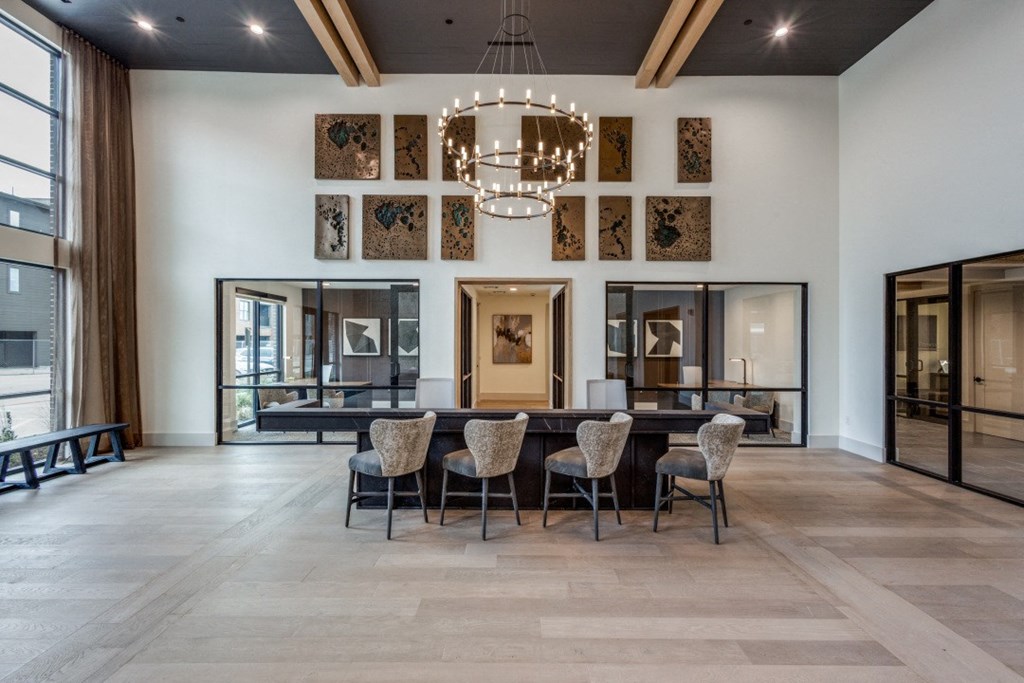 a dining room with a large table and chairs and a chandelier