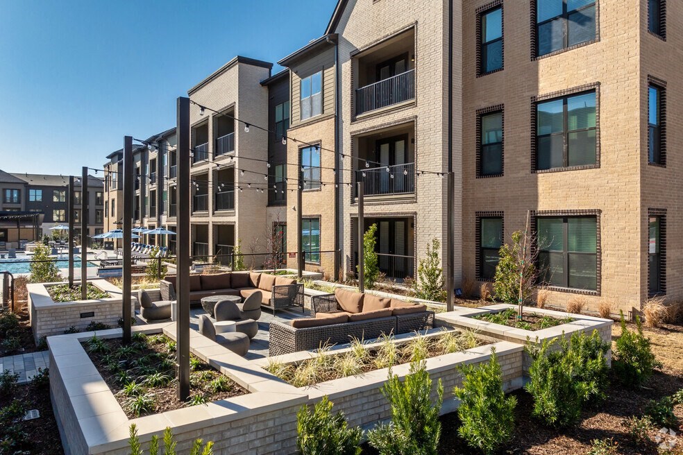 a view of a building with a patio and a pool