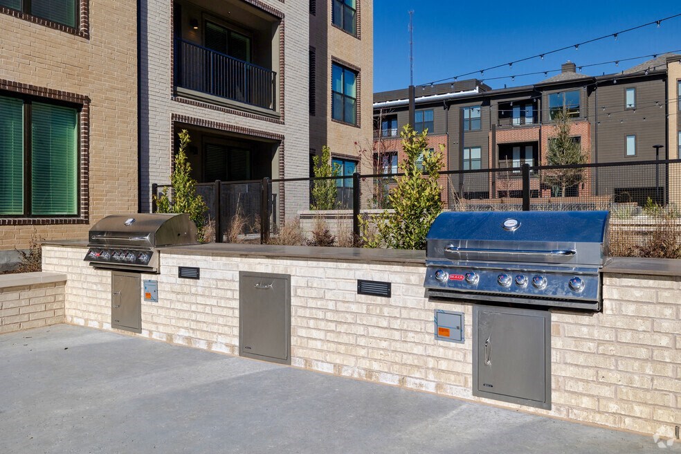 a brick wall with two grills in front of a building
