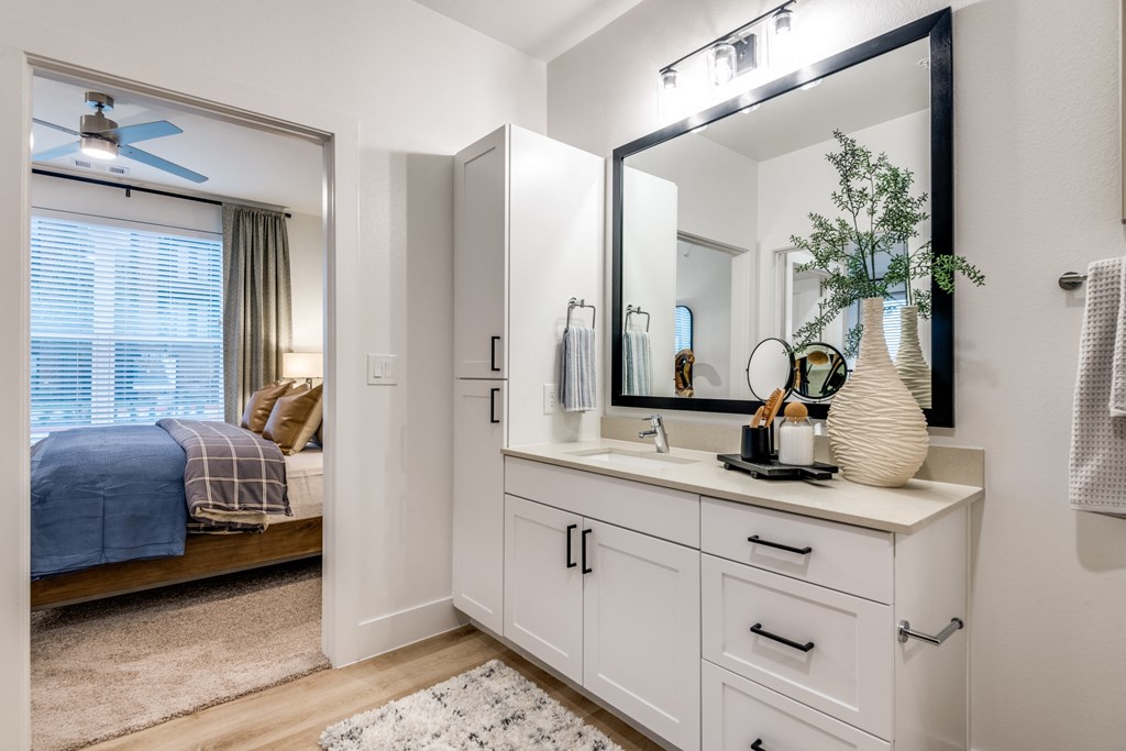 Aura 3Twenty Apartments bathroom with a large mirror and a vanity with a sink