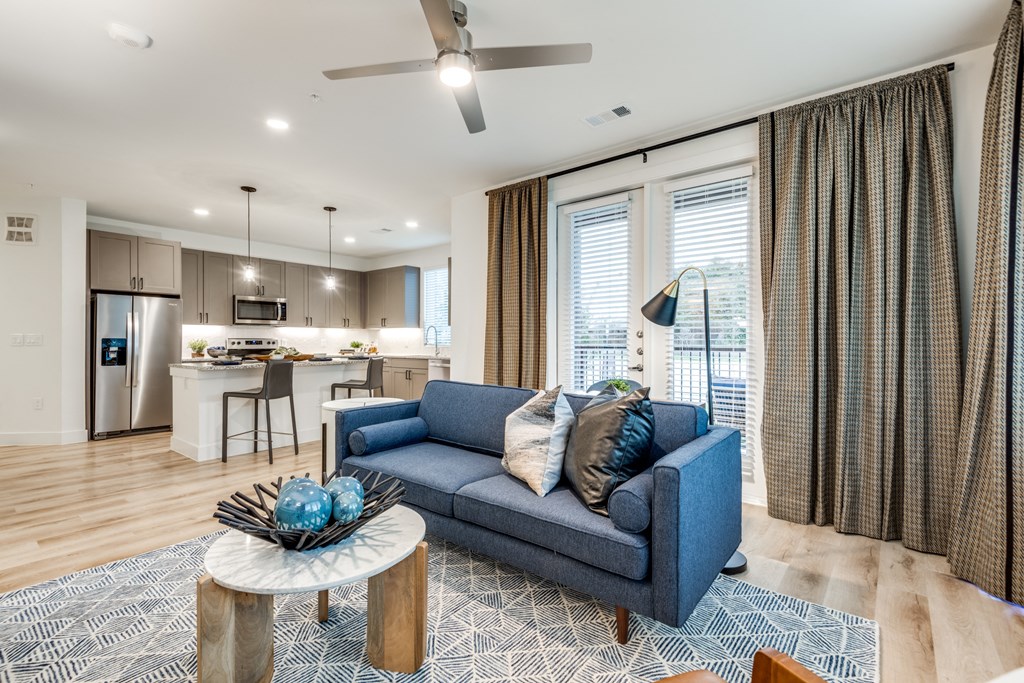 Aura 3Twenty Apartments a living room with a couch and a coffee table