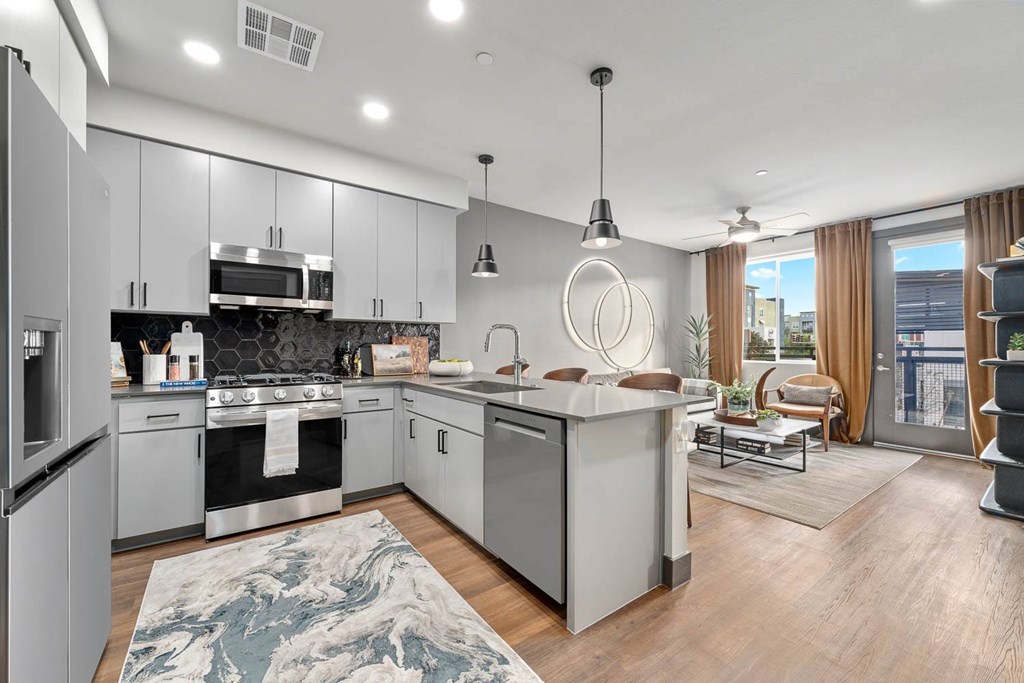 A modern kitchen with a large island and stainless steel appliances.