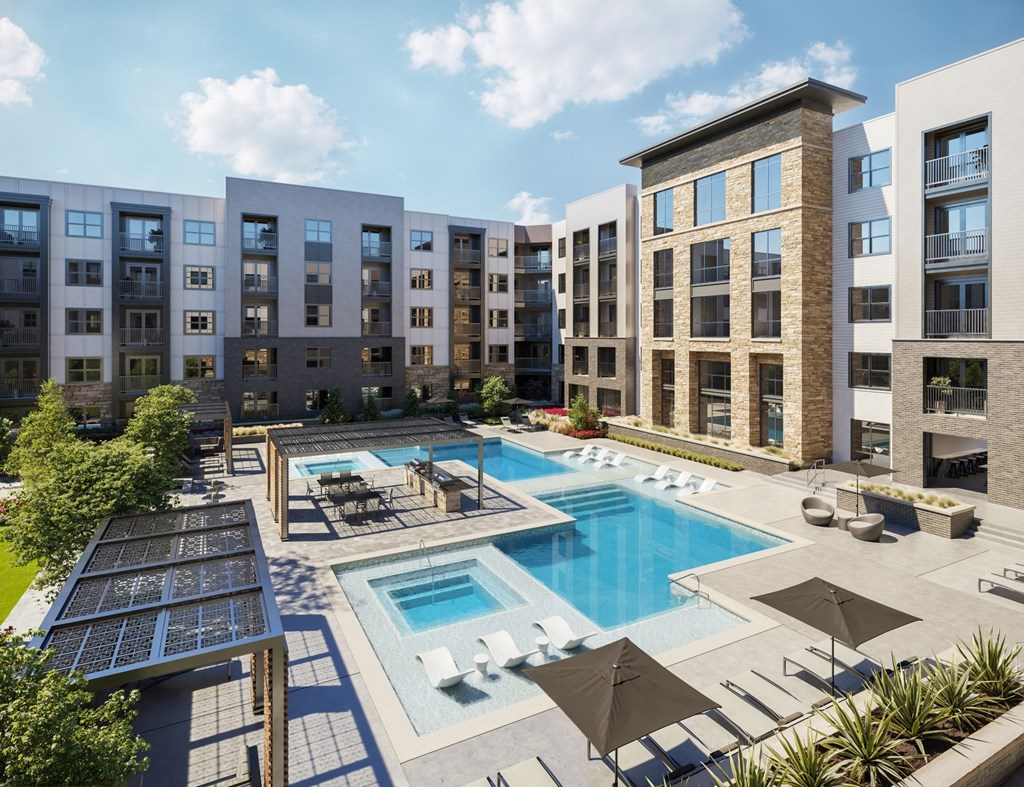 an aerial view of Aura Avant apartment complex with a swimming pool and umbrellas