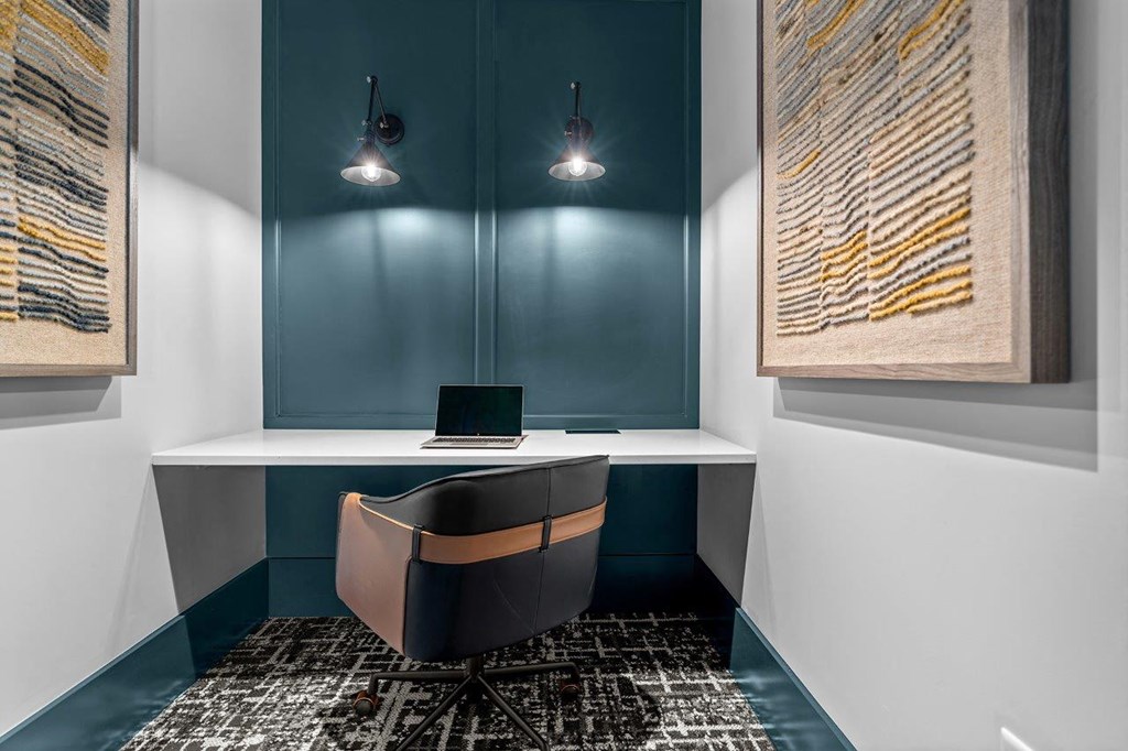 a corner desk with a laptop in a room with blue and white walls