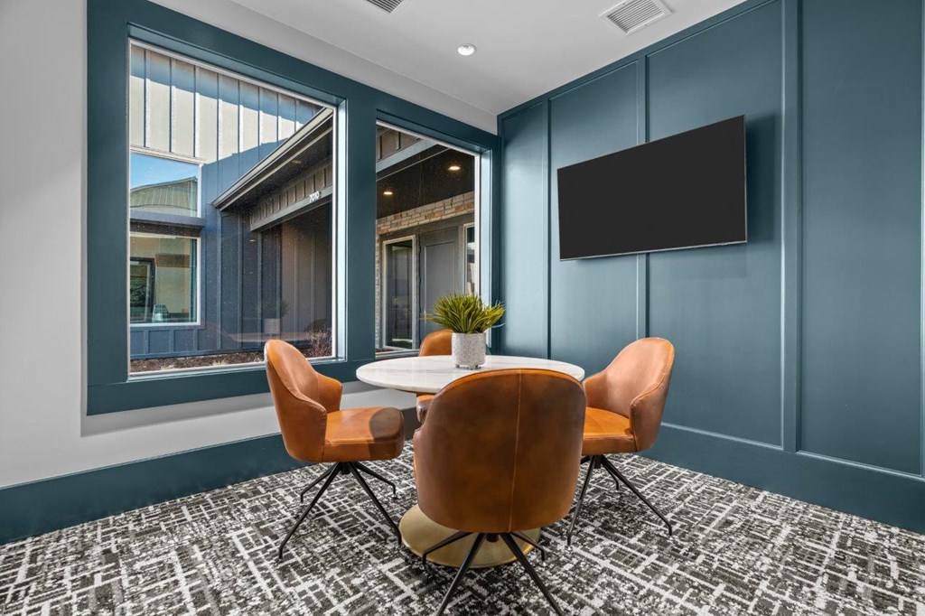a conference room with blue walls and a table and chairs