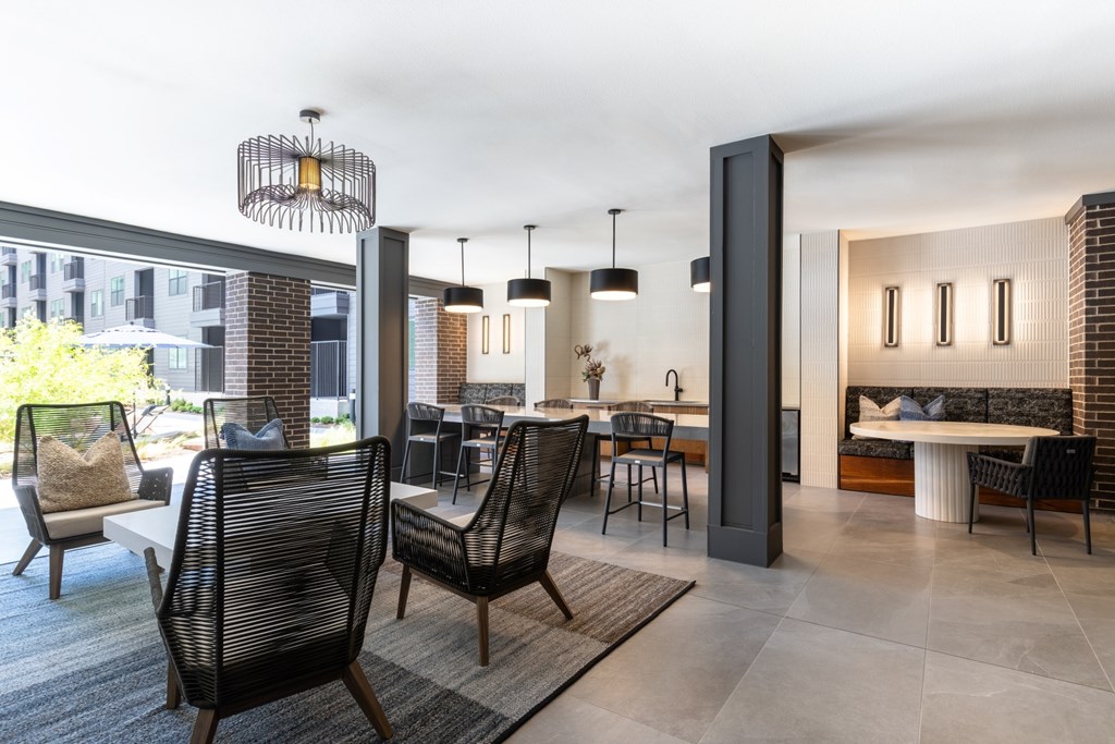 A modern living room with a black chair and a grey sofa.