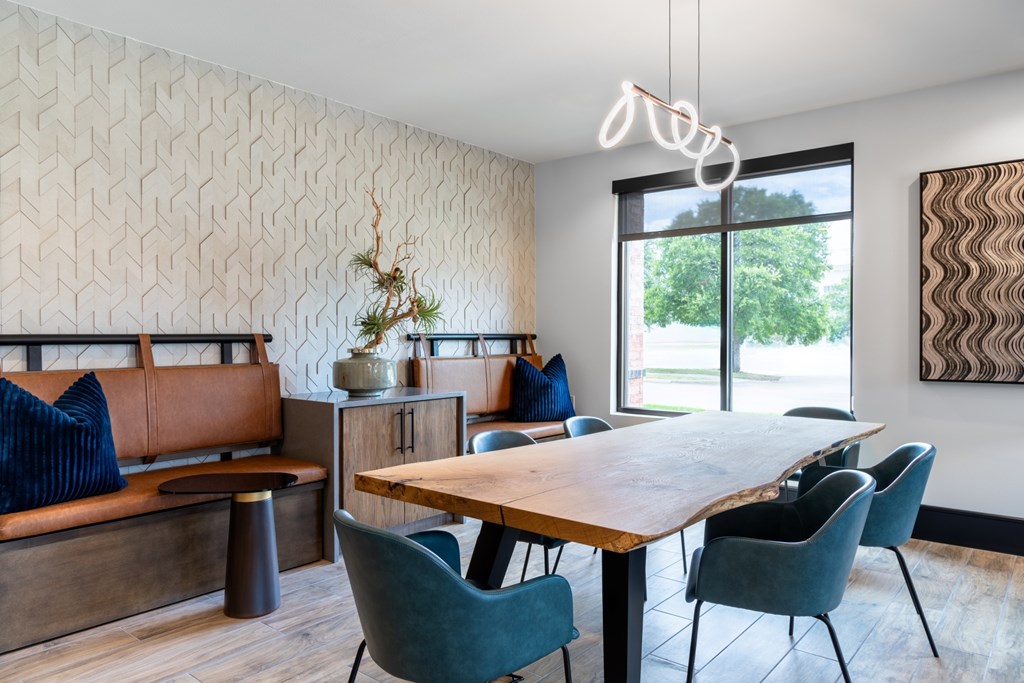 A dining room with a wooden table and blue chairs.