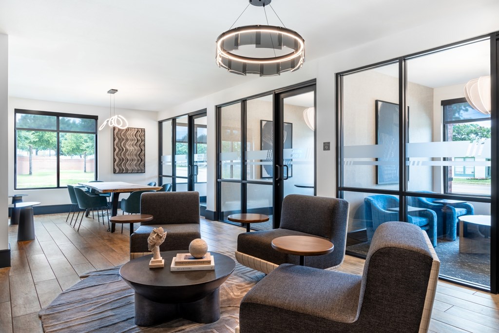 A modern living room with a large window and a wooden floor.