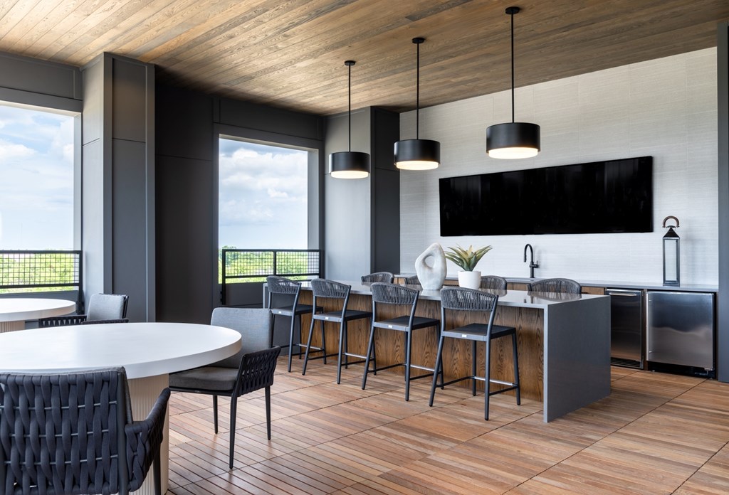 A modern kitchen with a dining table and chairs.