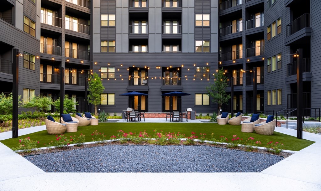 A modern building with a courtyard and a pool.