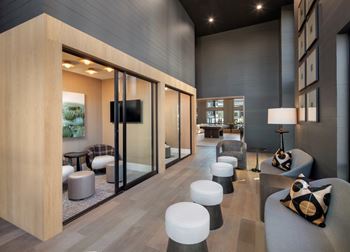 A modern living room with a grey couch and a television.