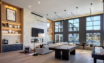 A modern living room with a pool table and a television.