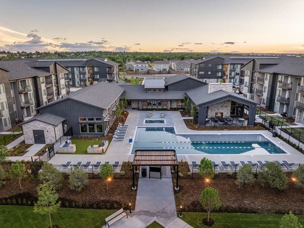 an aerial view of an apartment complex with a swimming pool