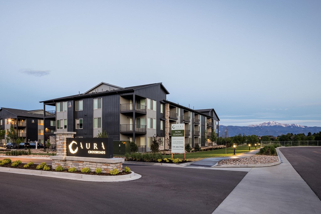 a large apartment building with a sign in front of it