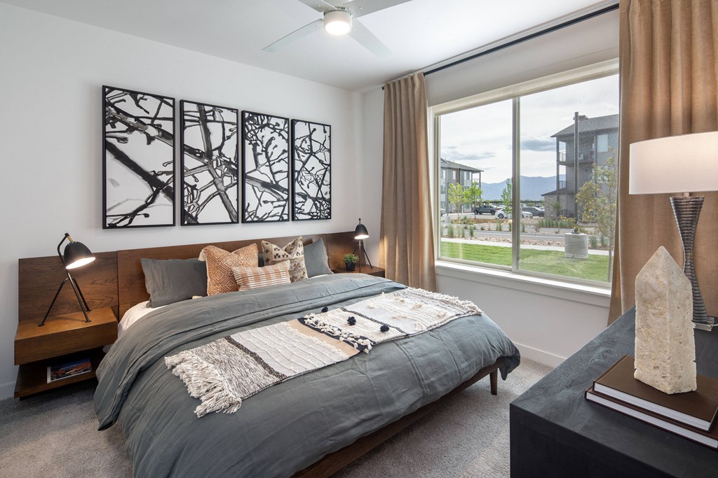 a bedroom with a bed and a large window