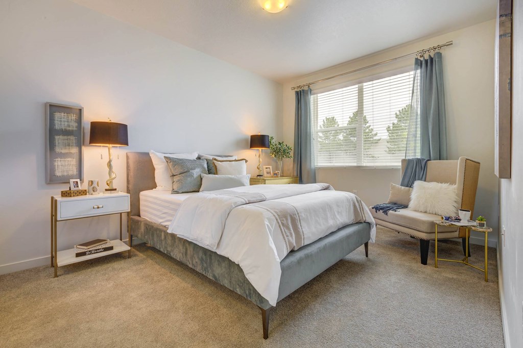 a bedroom with a bed and a chair