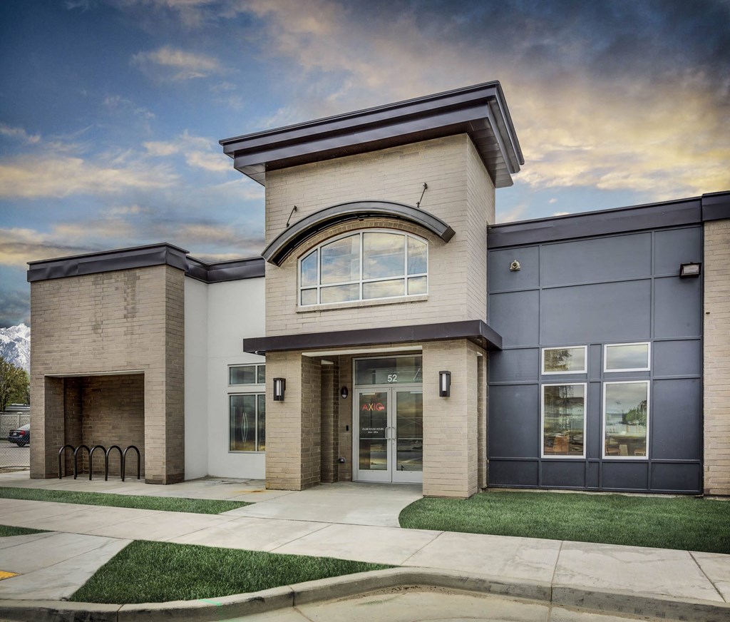a photo of the front of a building with a blue sky in the background