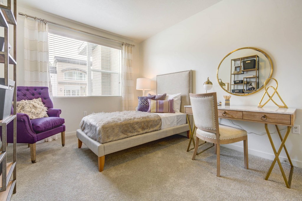 a bedroom with a bed and a desk