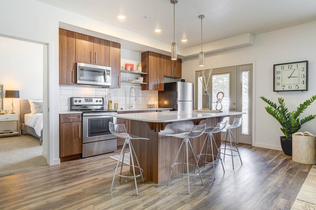 a kitchen with a large island with three stools