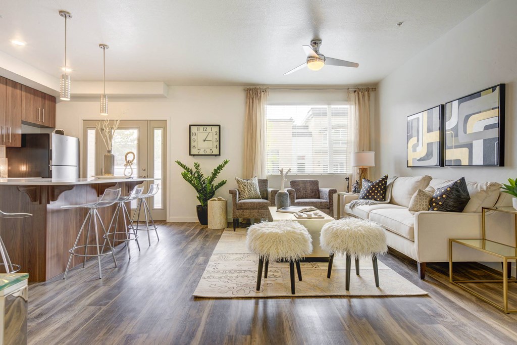 a living room with hardwood flooring and a ceiling fan