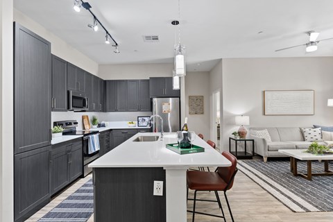 A modern kitchen with dark wood cabinets and a white island.