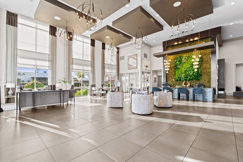 A spacious lobby with a reception desk and seating areas.