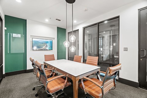 A conference room with a long table and chairs.
