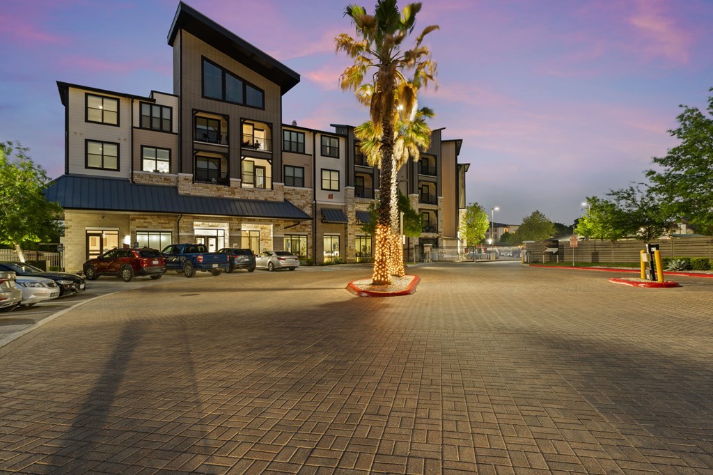 A large building with a parking lot in front of it.