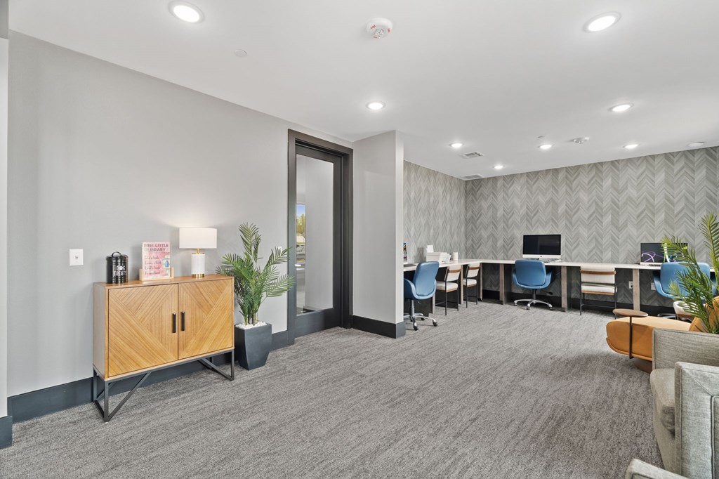 A conference room with a long table and chairs.