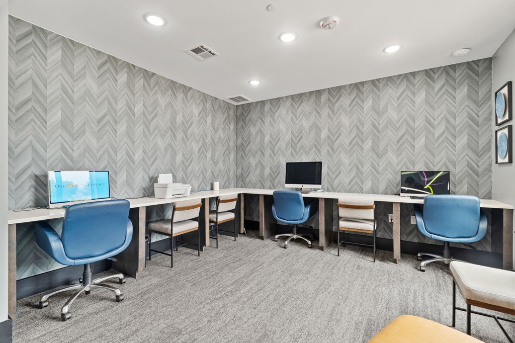 A room with grey patterned wallpaper and a grey carpet.