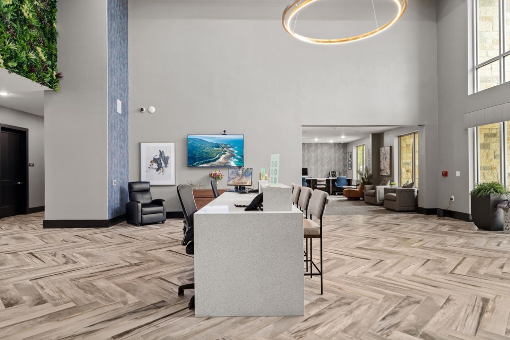 A modern office space with a large desk and comfortable seating.