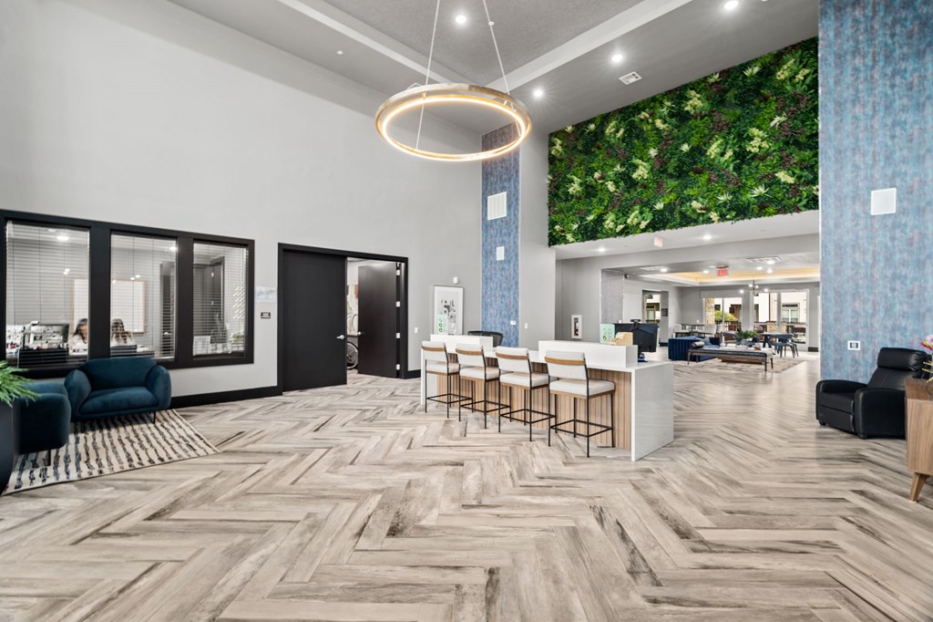 A modern office space with a green wall mural and wooden flooring.