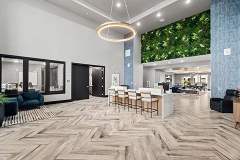 A modern office space with a green wall mural and wooden flooring.