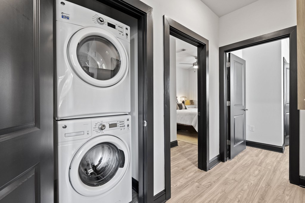 A modern laundry room with a washer and dryer stacked on top of each other.