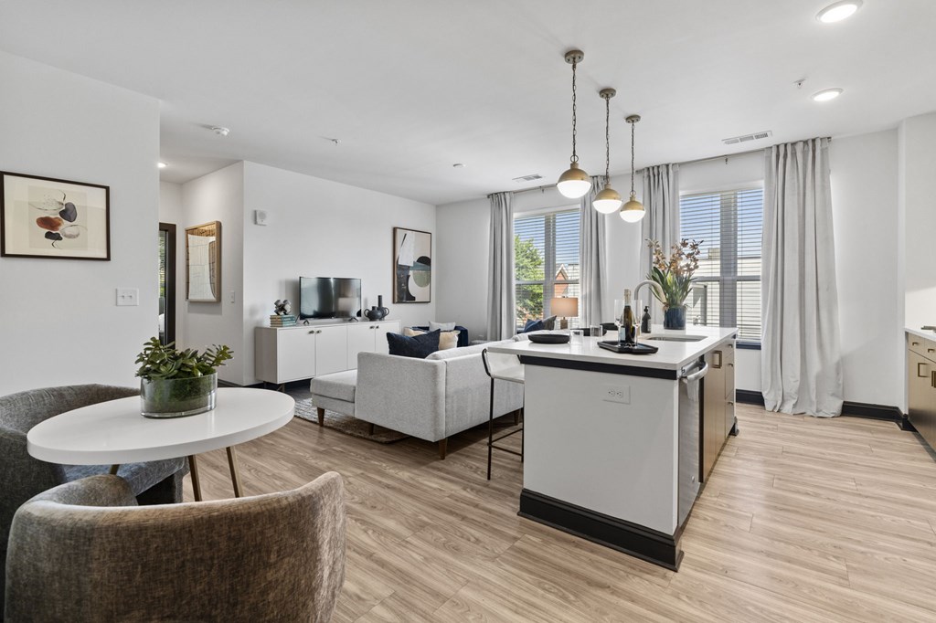 A modern kitchen with a dining table and chairs.