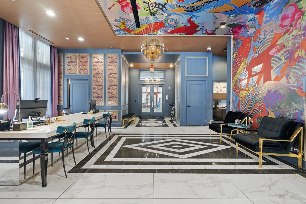 A room with a large mural on the wall and a black and white rug on the floor.