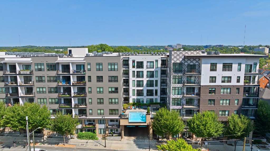 A large apartment complex with a pool in the middle.