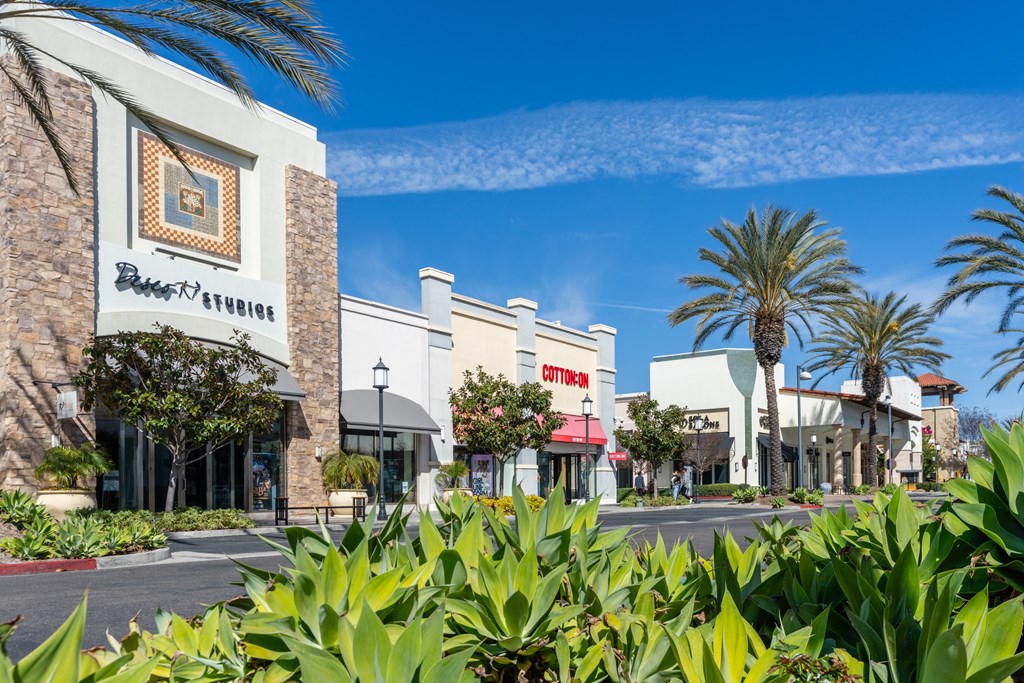 A shopping center with a clear blue sky above.