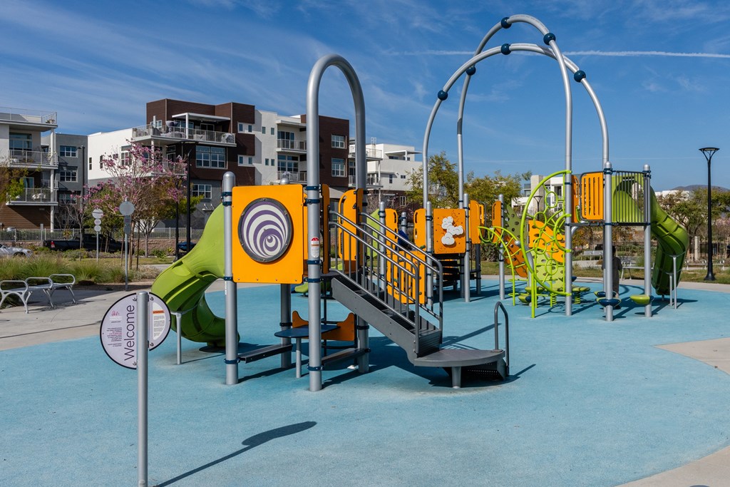 A playground with a slide, swings, and a climbing frame.