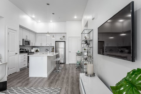 A modern kitchen with white cabinets and a large island.