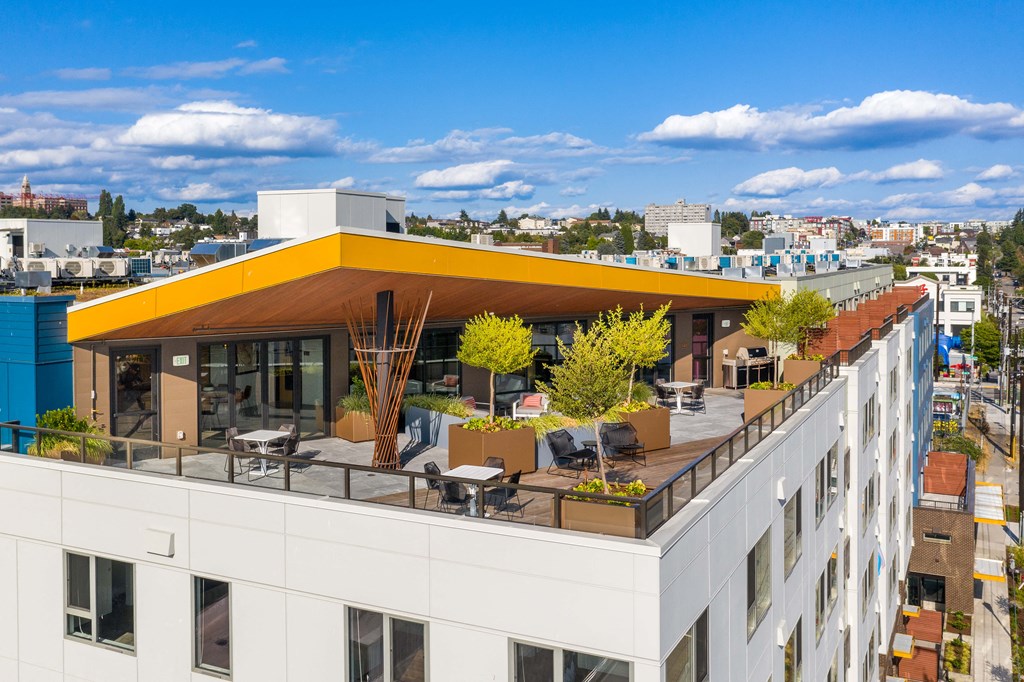 the rooftop terrace of a building with a yellow roof