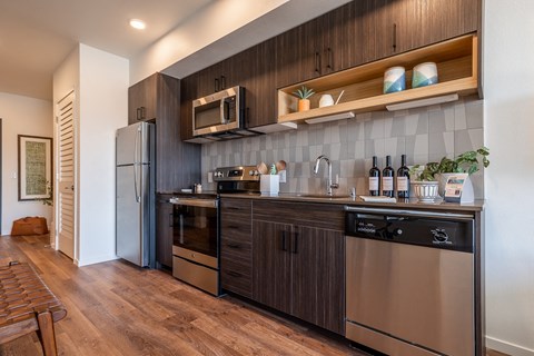 a kitchen with stainless steel appliances and wooden cabinets