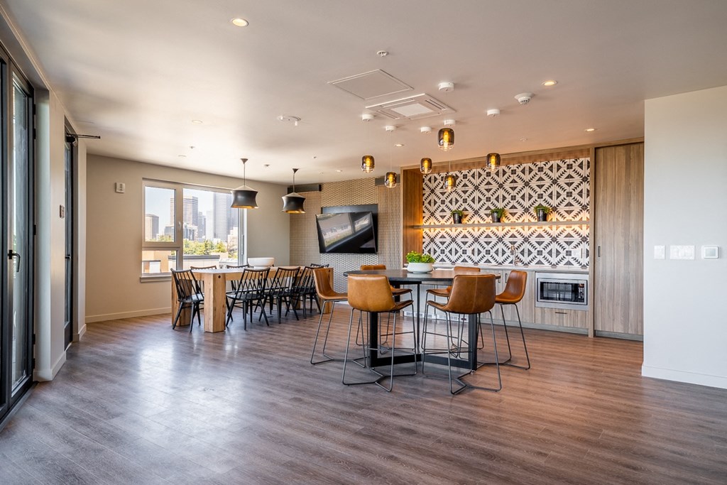 a dining room with a table and chairs and a television