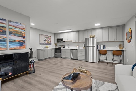 A modern kitchen with a fireplace and a dining table.