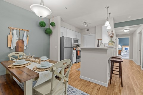 a kitchen and dining room with a table and chairs